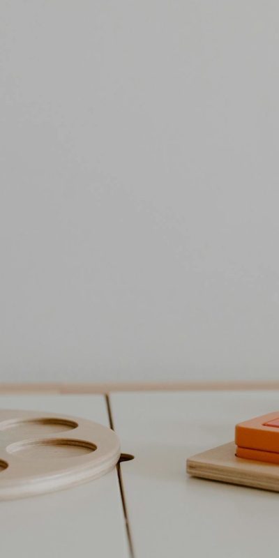 A minimalistic close-up of colorful wooden educational toys promoting sustainable learning.