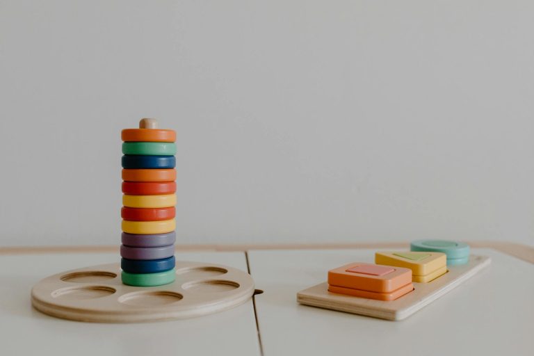 A minimalistic close-up of colorful wooden educational toys promoting sustainable learning.