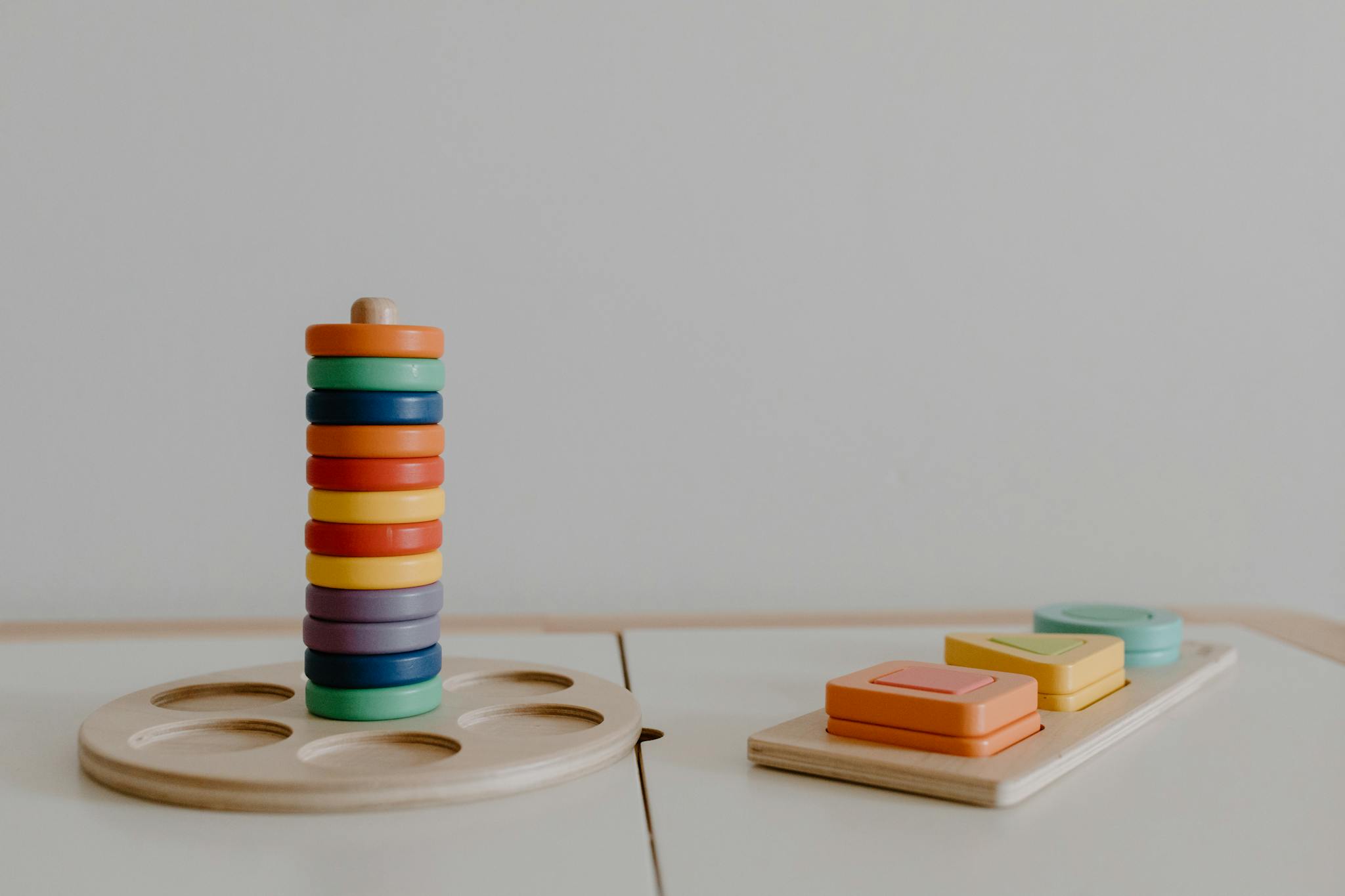 A minimalistic close-up of colorful wooden educational toys promoting sustainable learning.